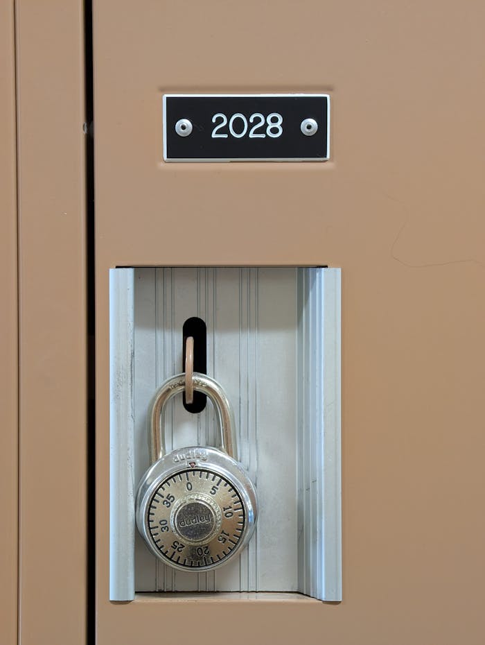 Close-up of a brown locker with a combination padlock and number 2028 visible. Secure and organized.