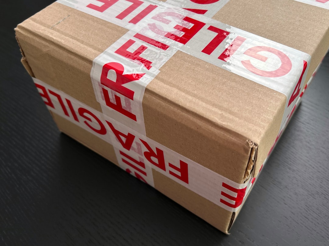 cardboard-box-sealed-with-red-fragile-tape-rqz-xgrncyi